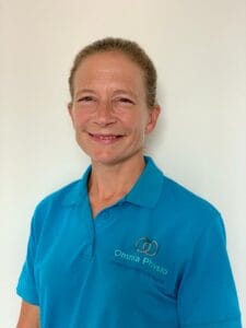 Woman in Omnia Physio shirt smiling