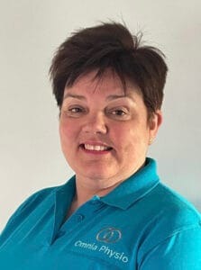 Smiling person in blue Omnia Physio shirt