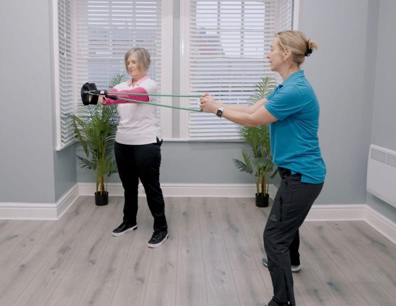 Two women exercising with resistance bands