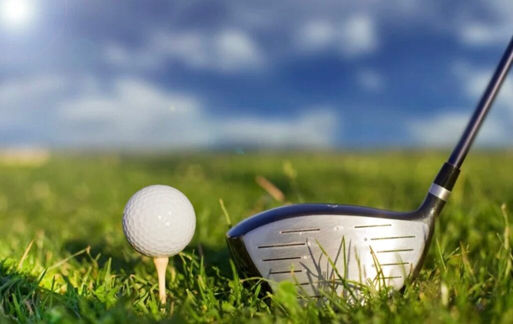 Golf club and ball on a tee